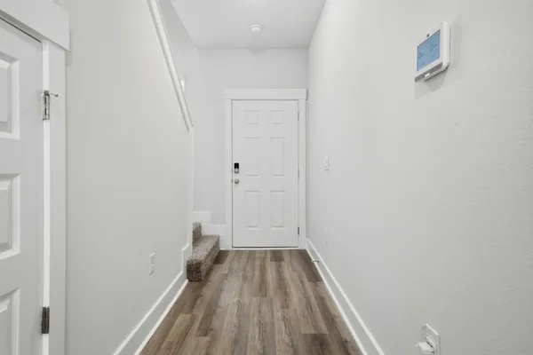 a view of a room with wooden floor