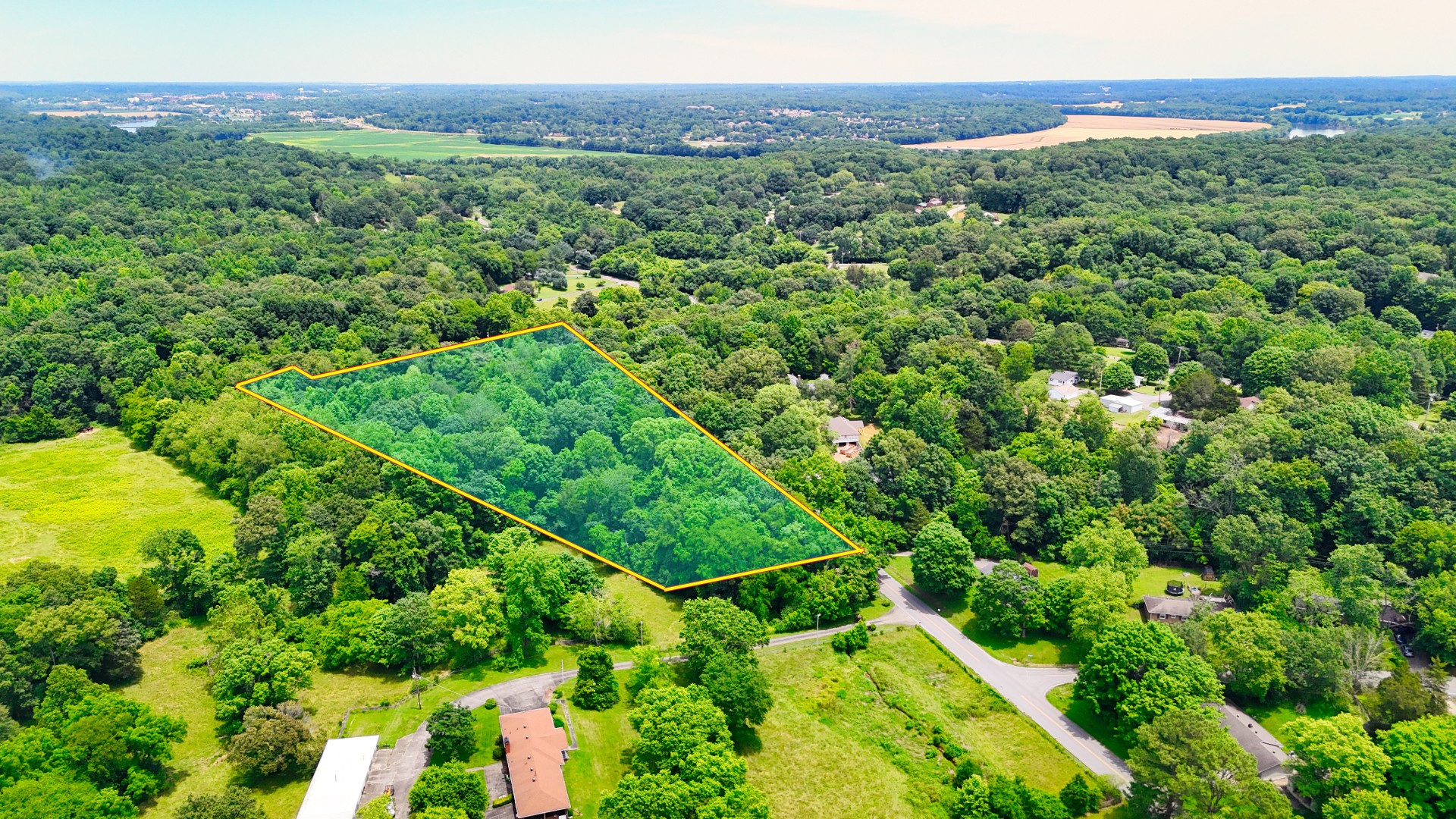 1 Dean Road Clarksville, TN 37040 - Photo 1 of 12 a view of a lush green forest with trees and some houses