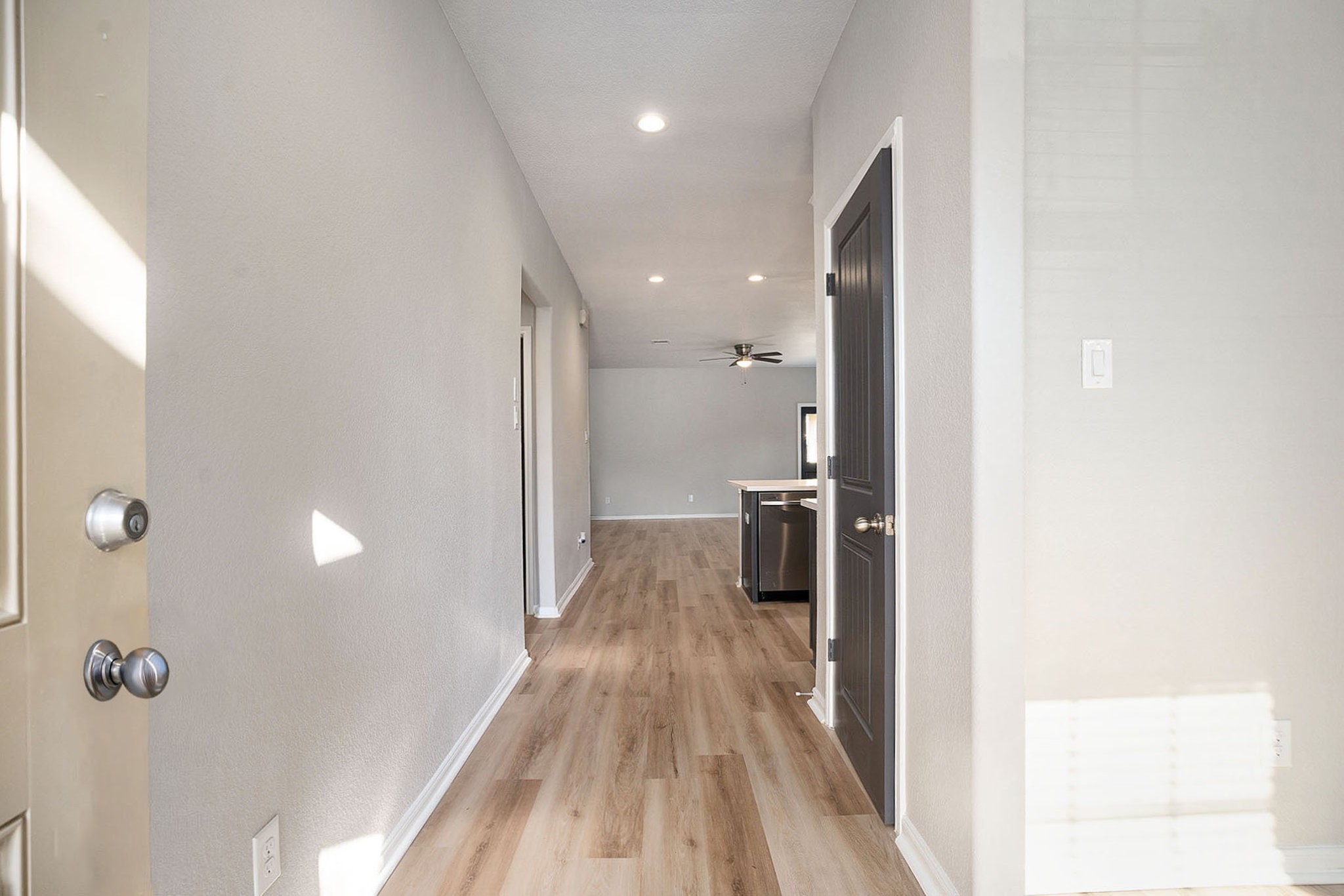 4027 Spurwing Lane Baytown, TX 77521 - Photo 5 of 34 Bright entry hallway with new flooring, freshly painted walls, and recessed lighting. Hall closet on the right.