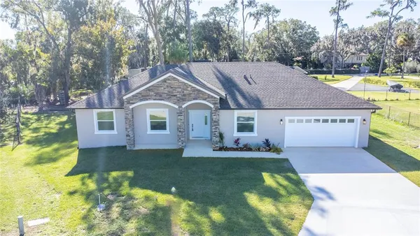 a aerial view of a house with swimming pool next to a yard