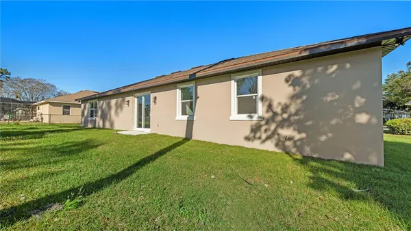 a front view of a house with a garden and plants