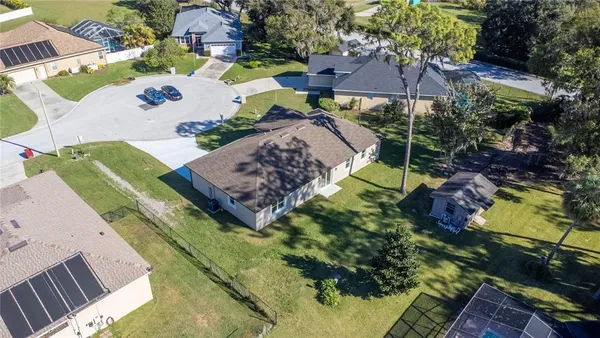 an aerial view of a house with a swimming pool yard and mountain view in back