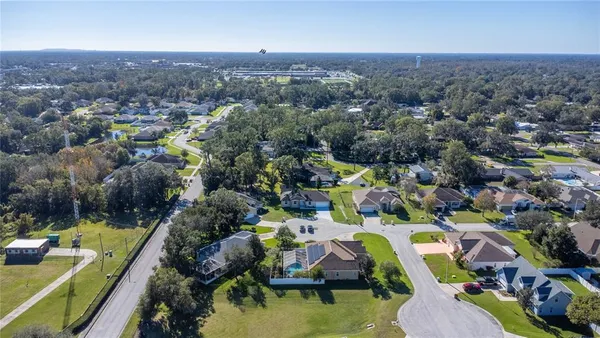 a aerial view of a house with a big yard plants and large trees