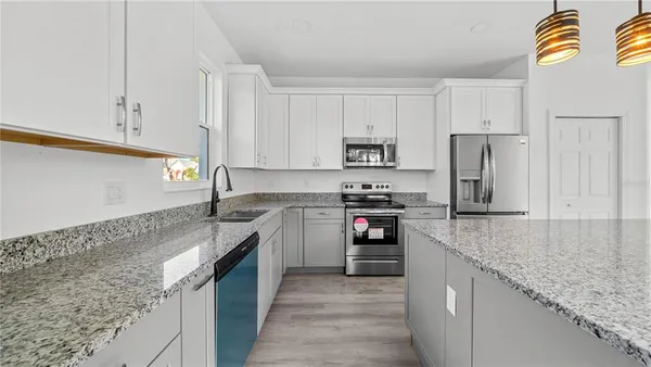 a kitchen with a sink stove and refrigerator