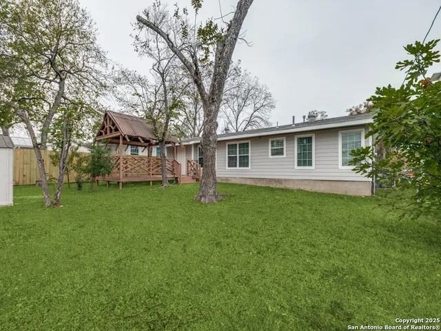 a view of a house with a backyard