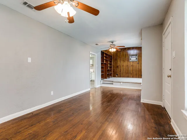 wooden floor in an empty room with a window