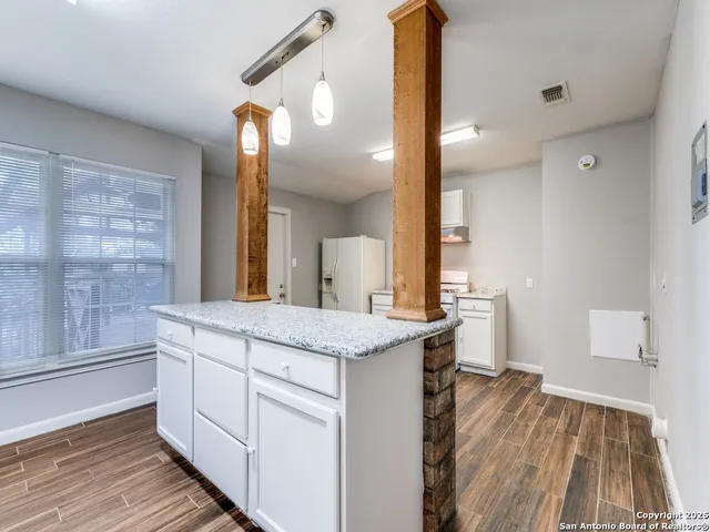 a kitchen with a sink and cabinets