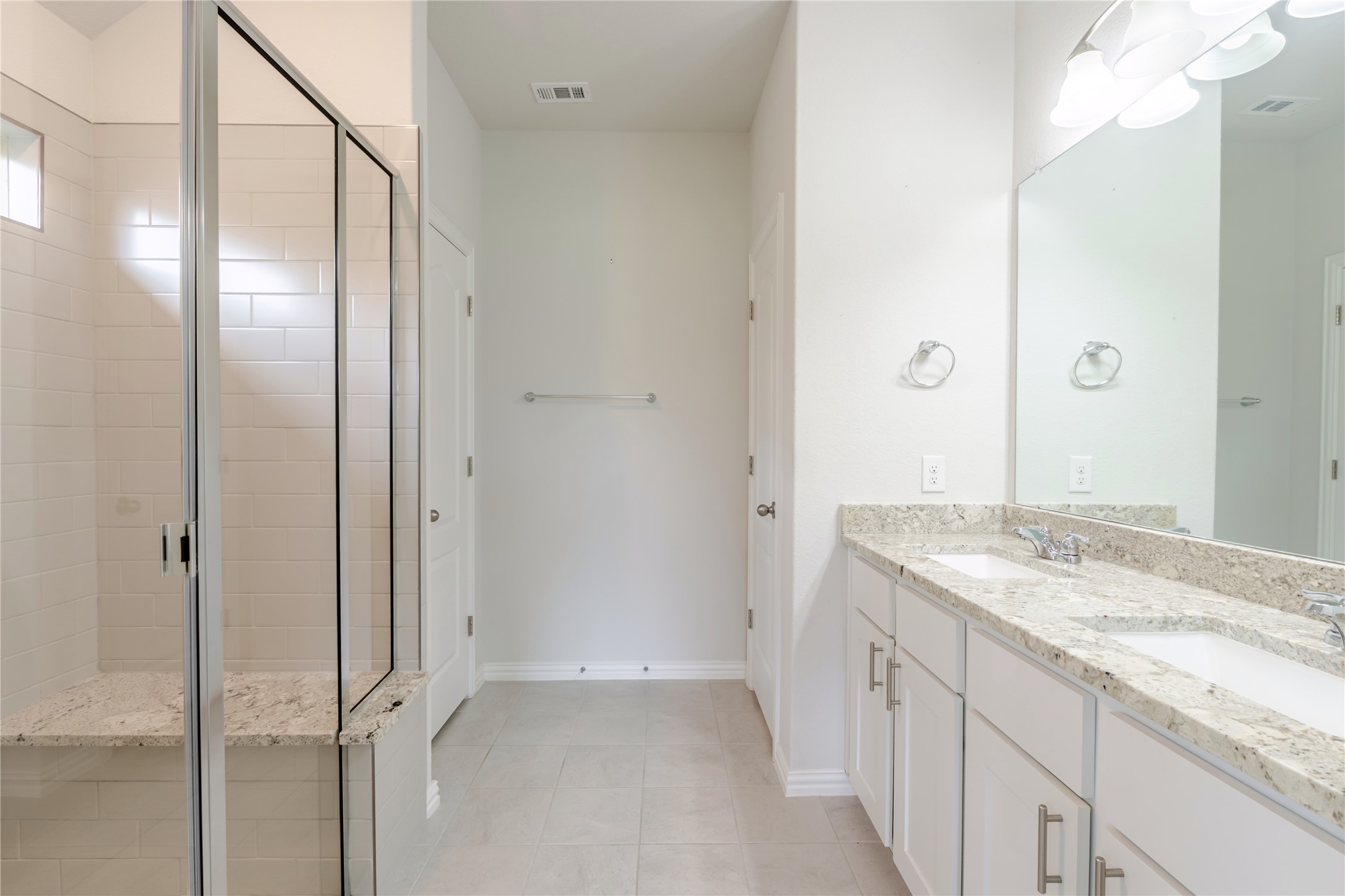 1117 Terrace View Georgetown, TX 78628 - Photo 20 of 25 Contemporary bathroom featuring a spacious glass-enclosed shower with subway tile surround and a built-in bench