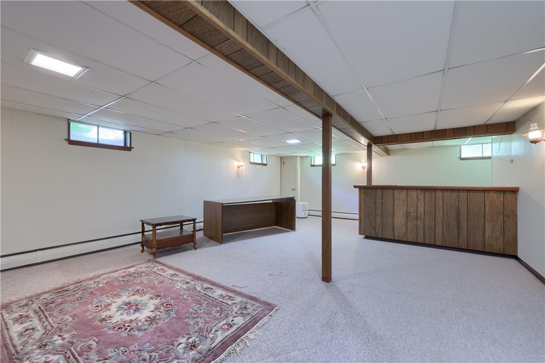 Coldsprings Rd Union Pottstown, PA 19465 - Photo 67 of 71 Finished basement offers ample space with practical window wells and a classic wooden bar area, perfect for entertaining.