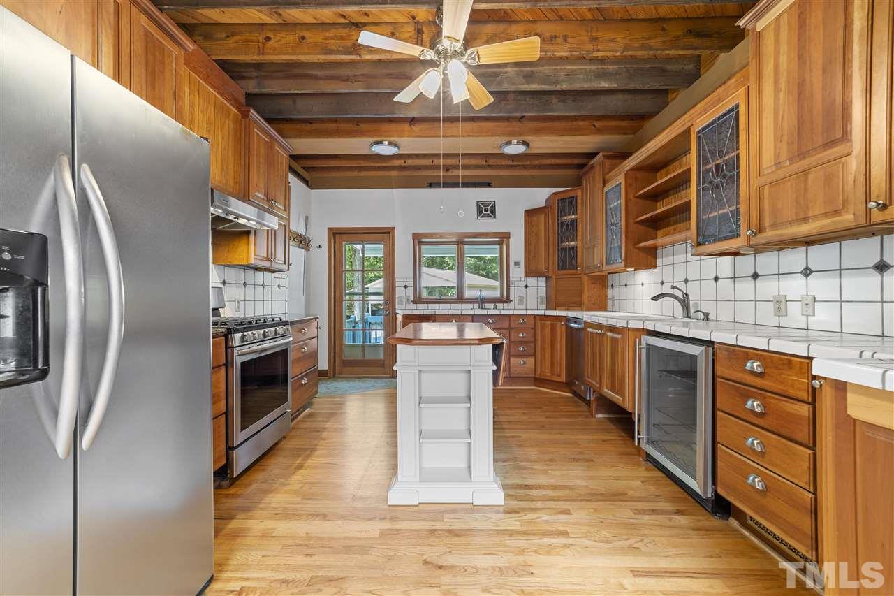 96 Silverberry Road Pittsboro, NC 27312 - Photo 12 of 30 This photo doesn't do justice to a lovely kitchen with gleaming cabinetry, gas range, pot racks, island, etc.