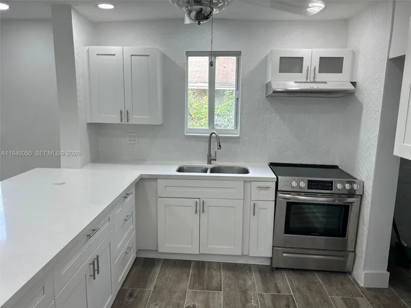 a bathroom with a granite countertop toilet and a sink