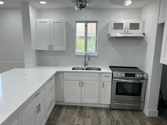 a bathroom with a granite countertop toilet and a sink
