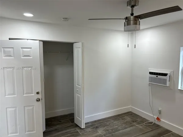 a view of a room with wooden floor