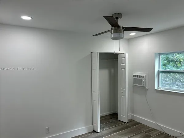 a room view with wooden floor and cabinets