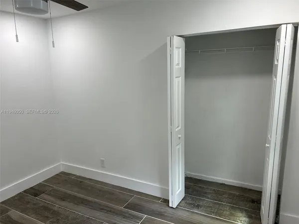 a view of living room with wooden floor and cabinet