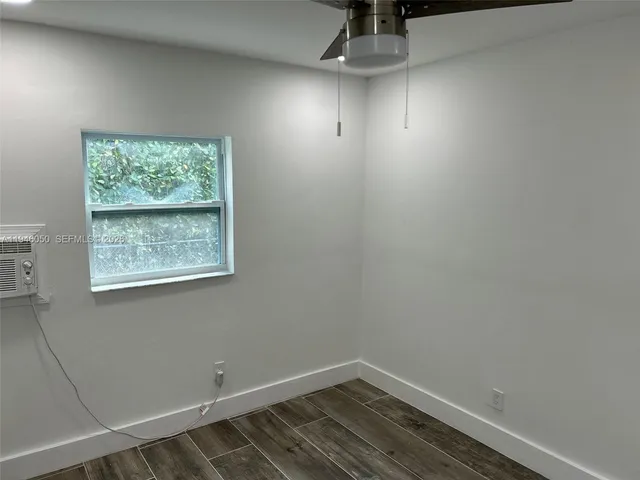 a bathroom with a granite countertop sink a toilet and a mirror