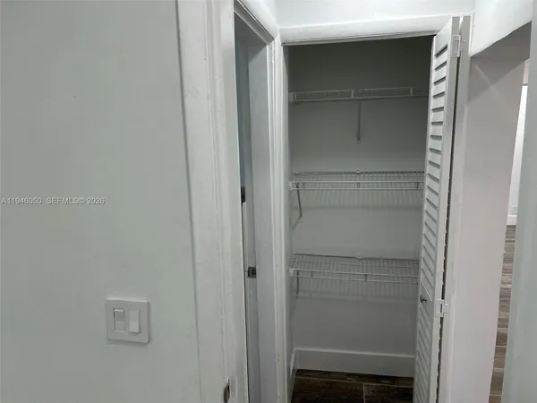 a large kitchen with a refrigerator and a sink