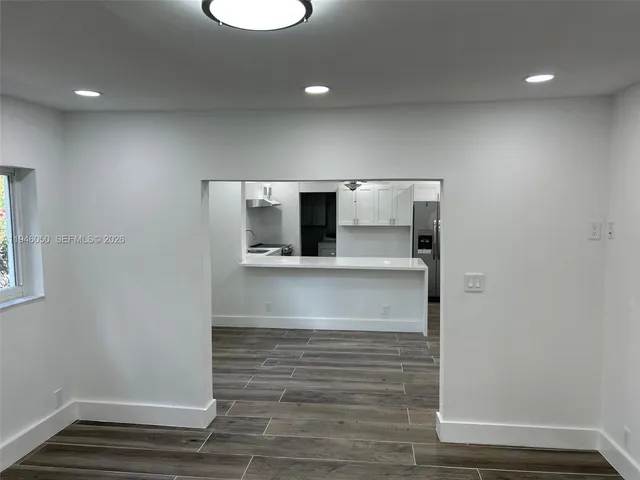 a view of front door with wooden floor