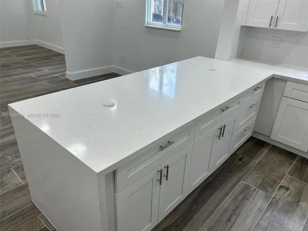 a kitchen with stainless steel appliances granite countertop a sink and dishwasher with wooden floor