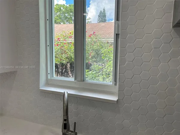 a bathroom with a shower and a sink