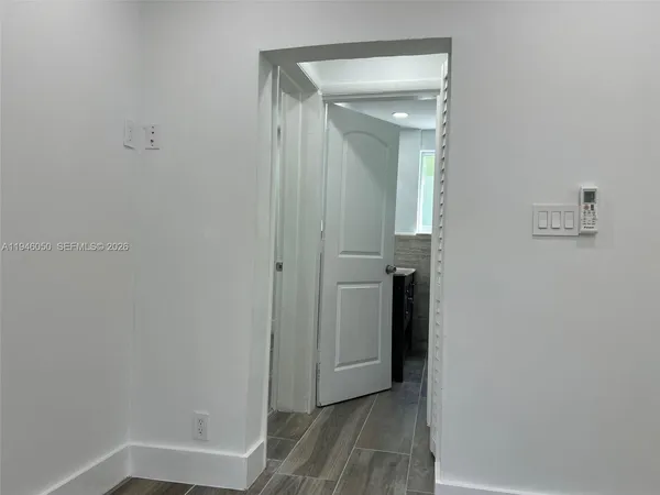 a bathroom with a granite countertop sink a mirror and shower