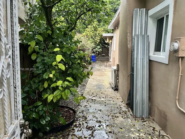 a view of a yard with wooden fence