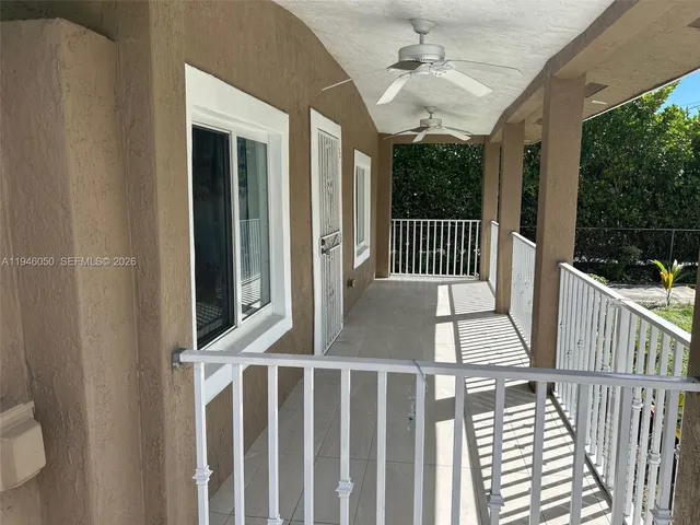an empty room with wooden floor and a flat screen tv