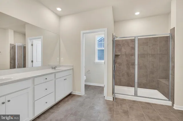 a spacious bathroom with a shower and a sink