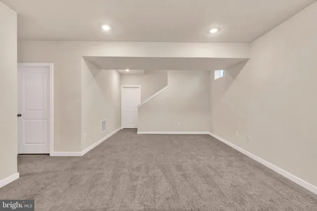 an empty room with a empty space and windows