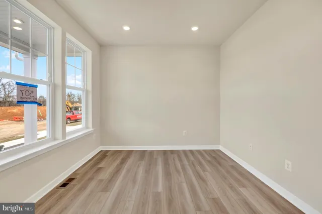 a view of room with window and wooden floor