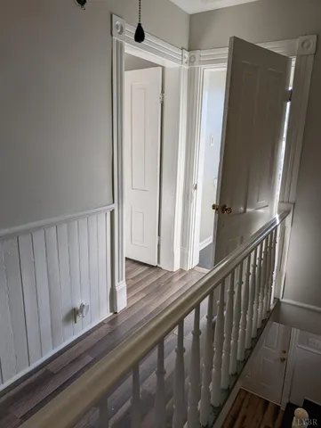a view of a hallway with wooden floor