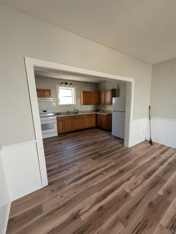 a room with a bed and dresser