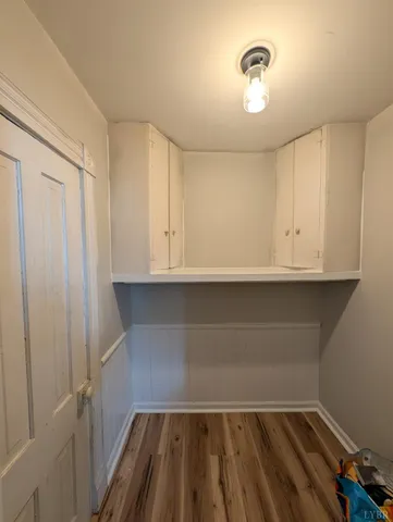 a view of storage and utility room with wooden floor