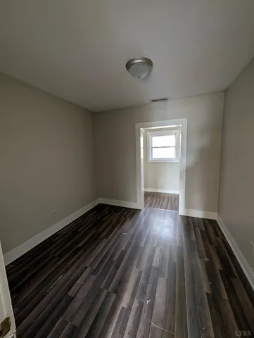 a view of wooden floor and in an empty room