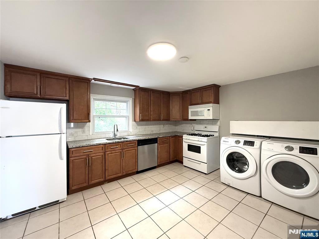 175 Van Winkle Street, Unit 2 East Rutherford, NJ 07073 - Photo 9 of 20 a kitchen with stainless steel appliances granite countertop a sink a stove a refrigerator and cabinets