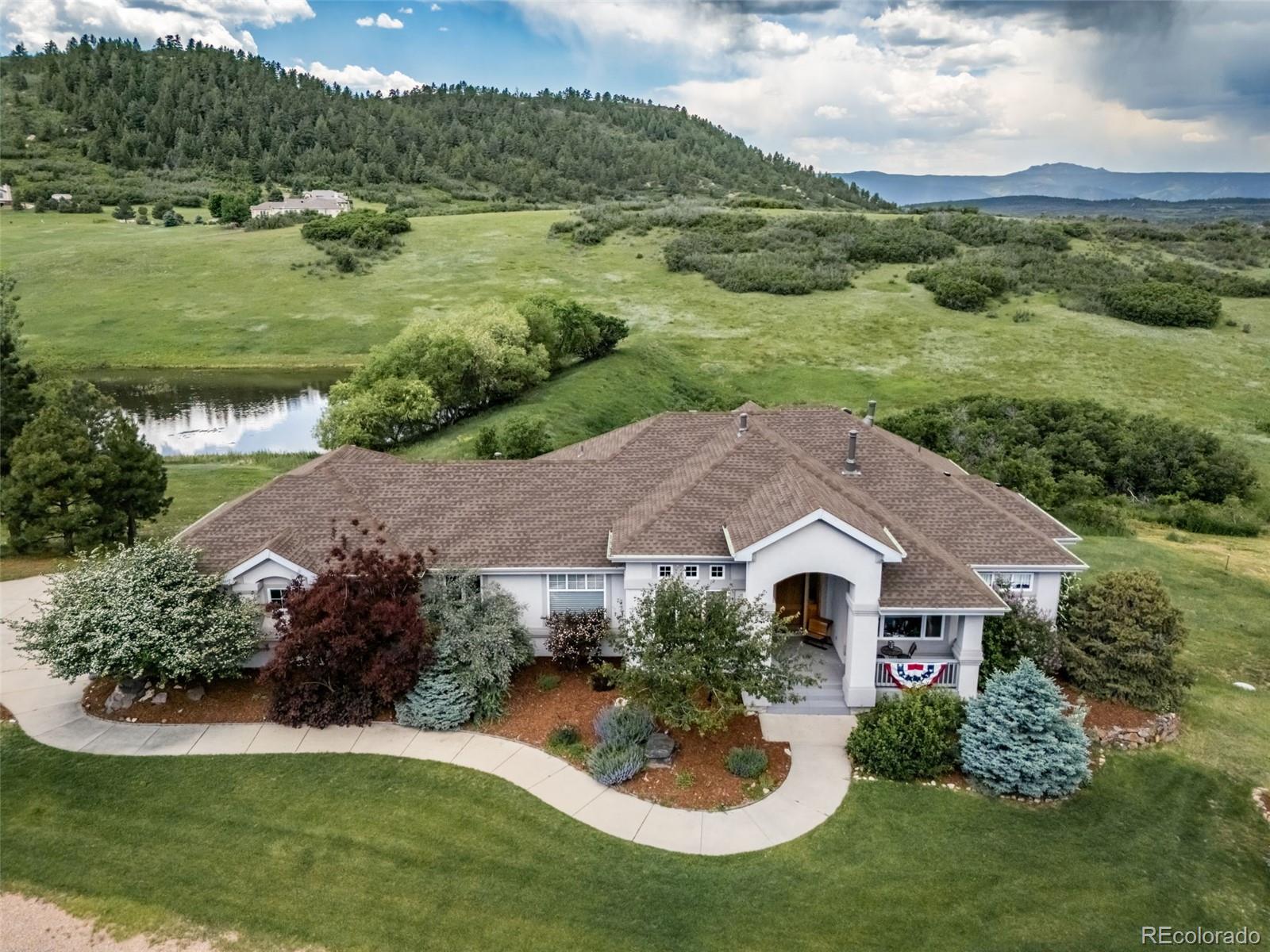 a aerial view of a house with yard and green space