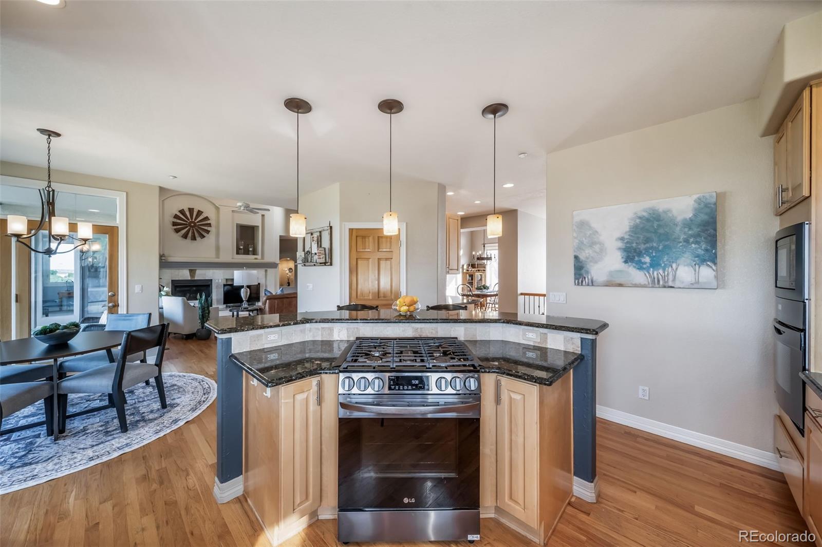 4612 High Spring Road Castle Rock, CO 80104 - Photo 19 of 50 a kitchen with stainless steel appliances granite countertop a stove a sink and a wooden floors