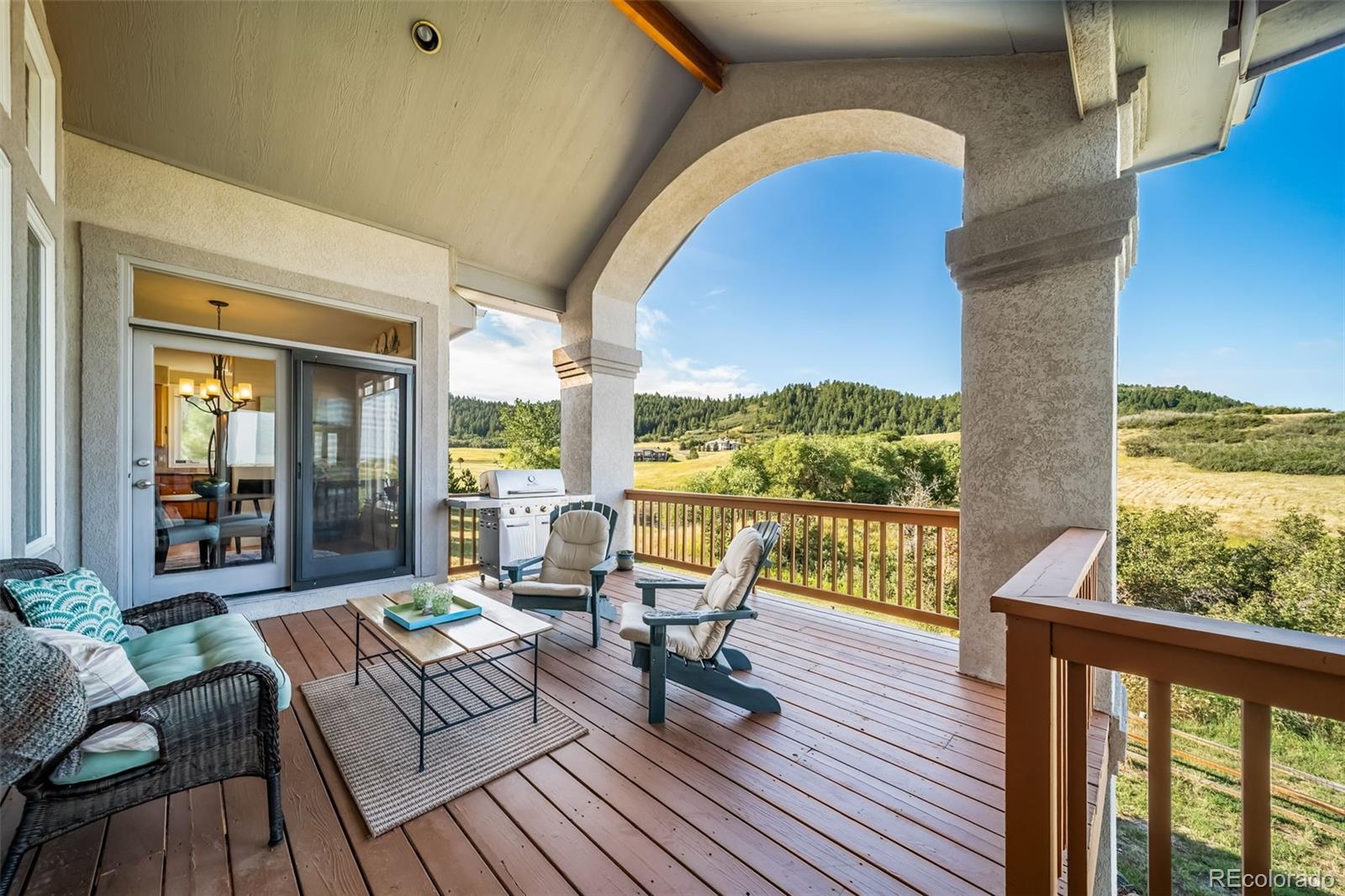 4612 High Spring Road Castle Rock, CO 80104 - Photo 24 of 50 a balcony with wooden floor table and chairs