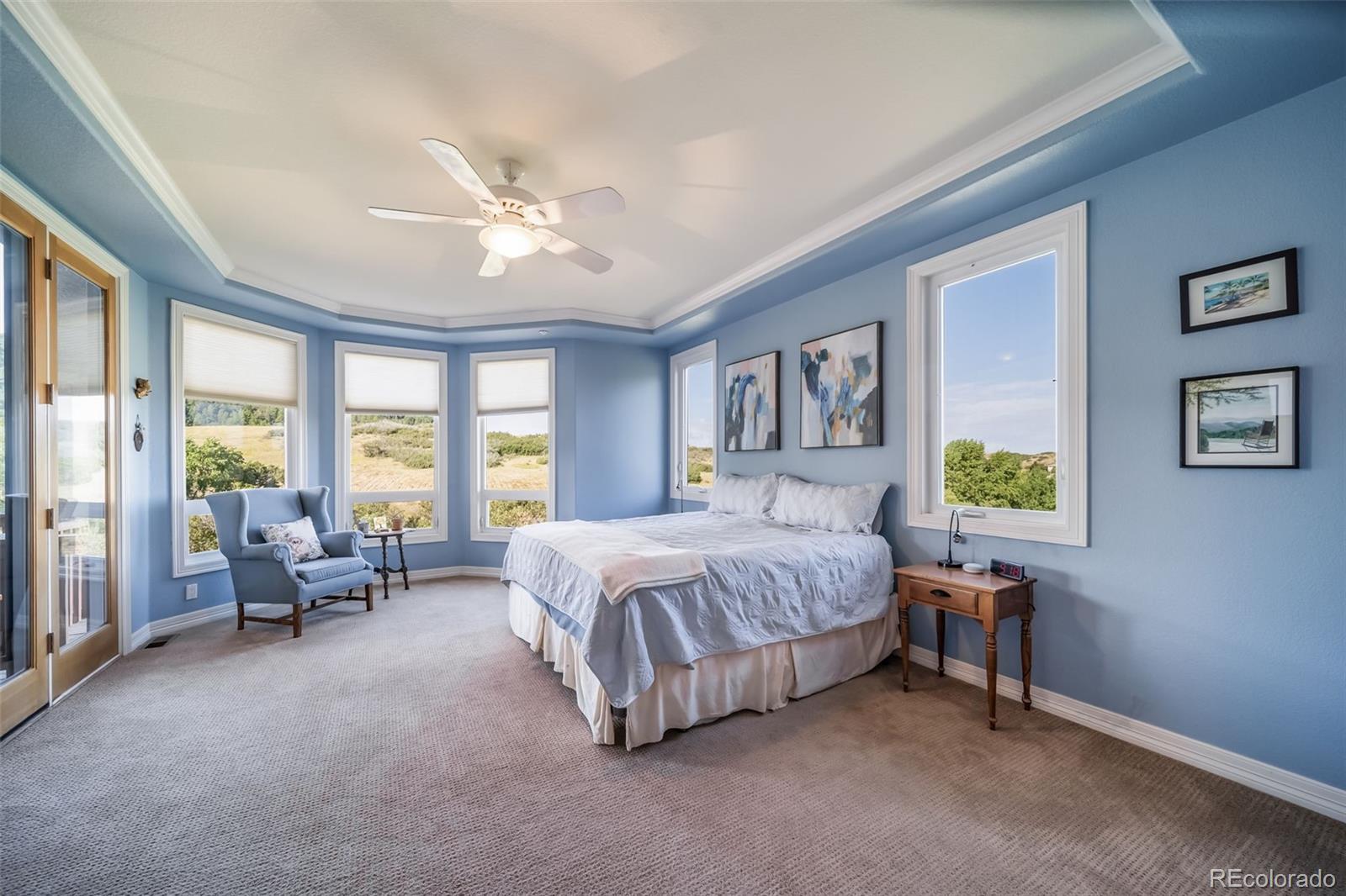 4612 High Spring Road Castle Rock, CO 80104 - Photo 27 of 50 a spacious bedroom with a bed and a chandelier