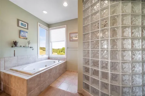 a bathroom with a tub sink and mirror