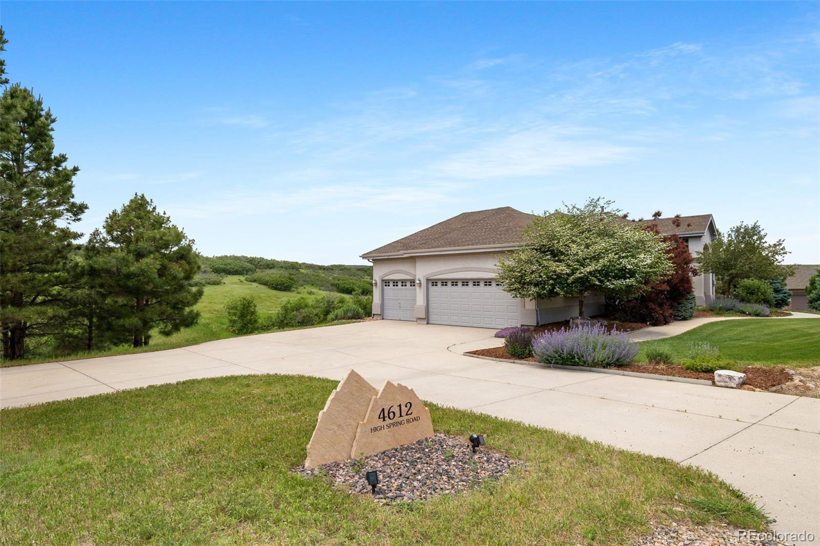 4612 High Spring Road Castle Rock, CO 80104 - Photo 3 of 50 a front view of a house with a yard