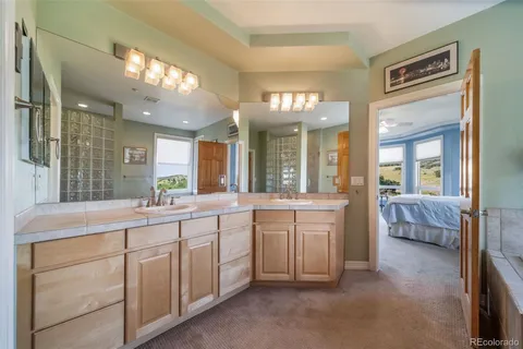 a large bathroom with a large mirror vanity and sink