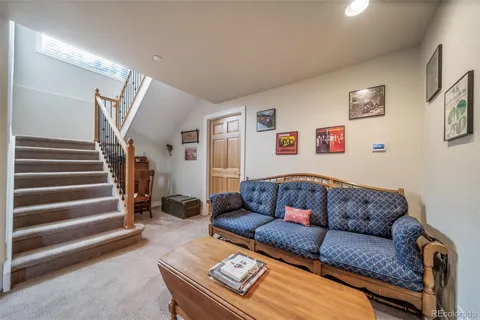 a living room with furniture and a stairs