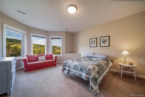 a bedroom with a bed and a couch