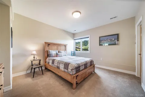 a bed sitting in a bedroom next to a lamp