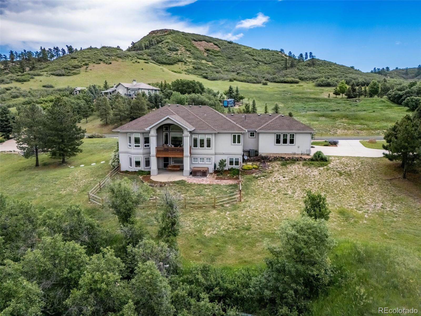 4612 High Spring Road Castle Rock, CO 80104 - Photo 45 of 50 a view of a big house with a big yard and large trees