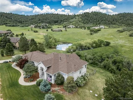 an aerial view of a houses with outdoor space and lake view