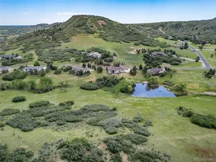a view of a lush green hillside and houses