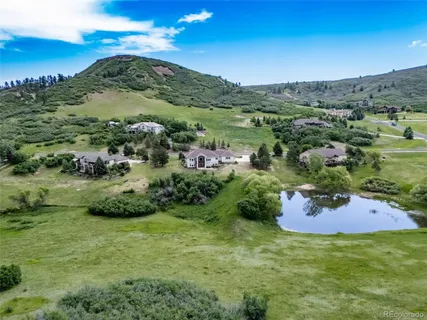 a view of a lush green hillside and houses