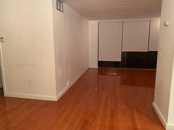 a view of hallway with wooden floor
